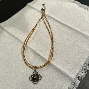 Tan beaded necklace with handing charm